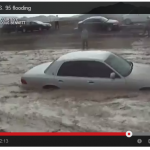 A picture of two cars floating down the median along interstate 25 near Las Vegas, Nevada.