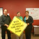 Curt Temple receiving the first Turn Around Don't Drown signs from Bill Borthwick in Lincoln County.